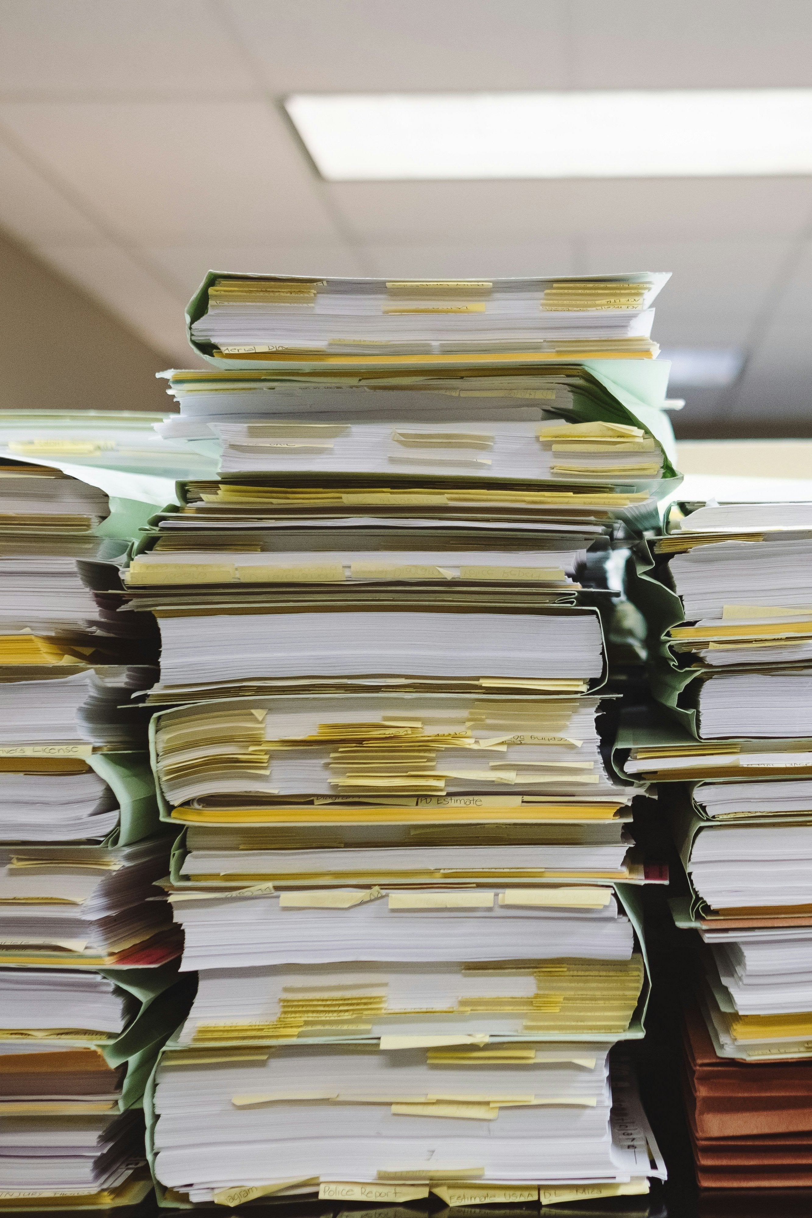 a picture of tacks of papers inside dividers